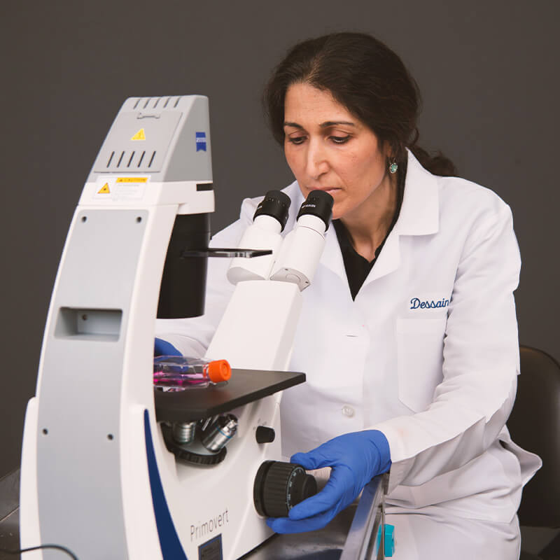 Cancer researcher using microscope